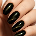 Close-up of black cat eye nails with a sharp metallic shimmer