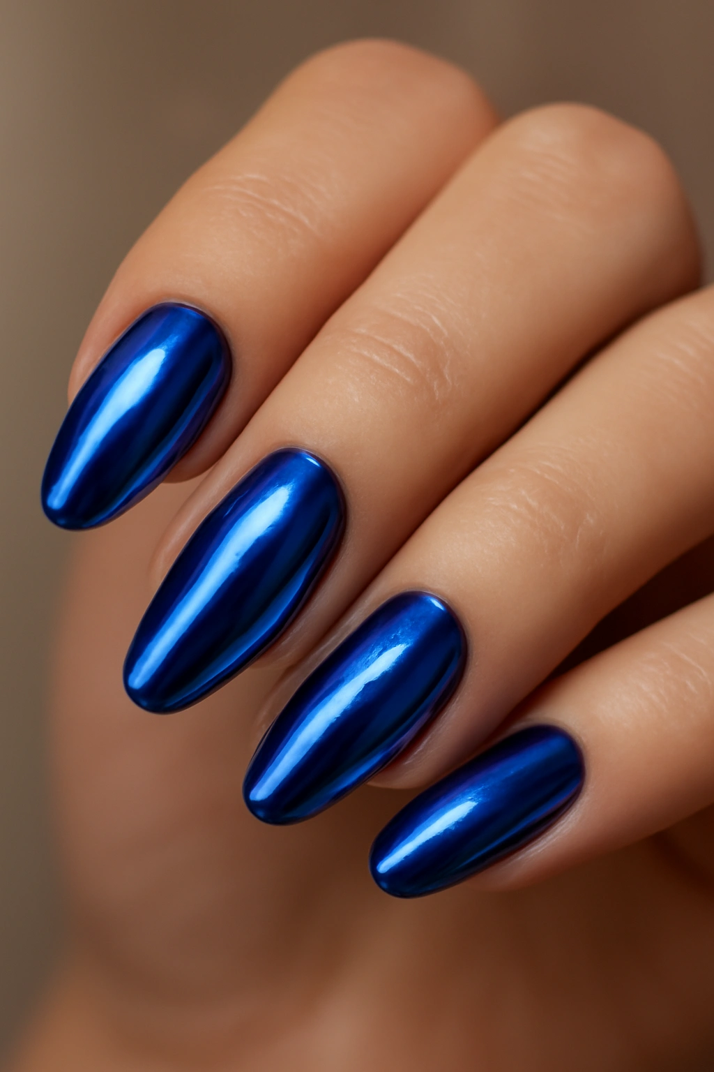 Close-up of blue chrome nails with cobalt to sapphire reflections