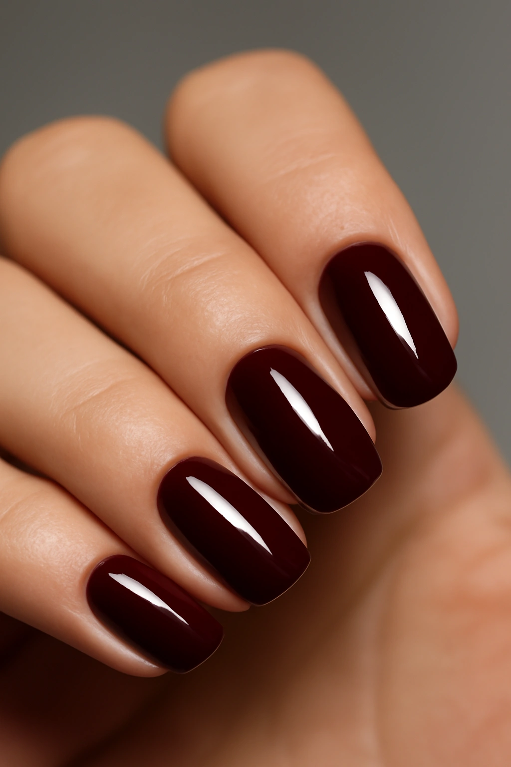 Close-up of burgundy nails with glossy shine