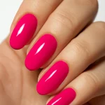 Close-up of nails painted in hot pink with a high-gloss finish