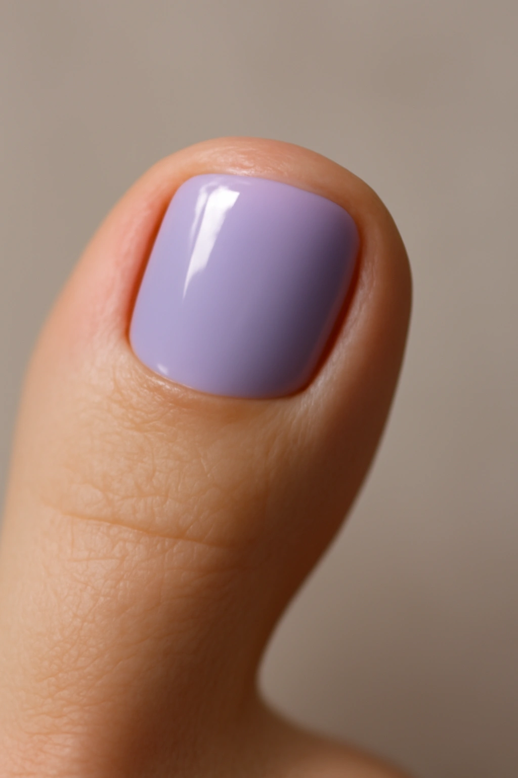 Close-up of a lavender toenail with glossy finish