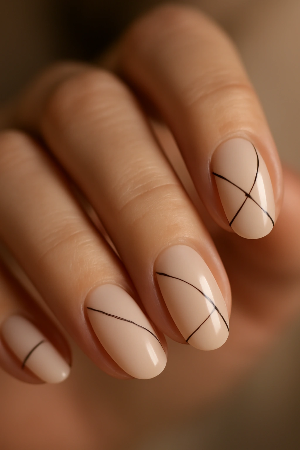 Nails with minimalist line art on a nude base