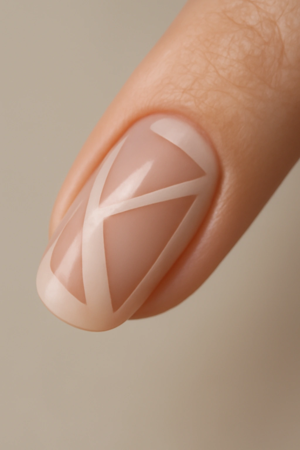 Close-up of a nail with negative-space geometric design on a sheer base