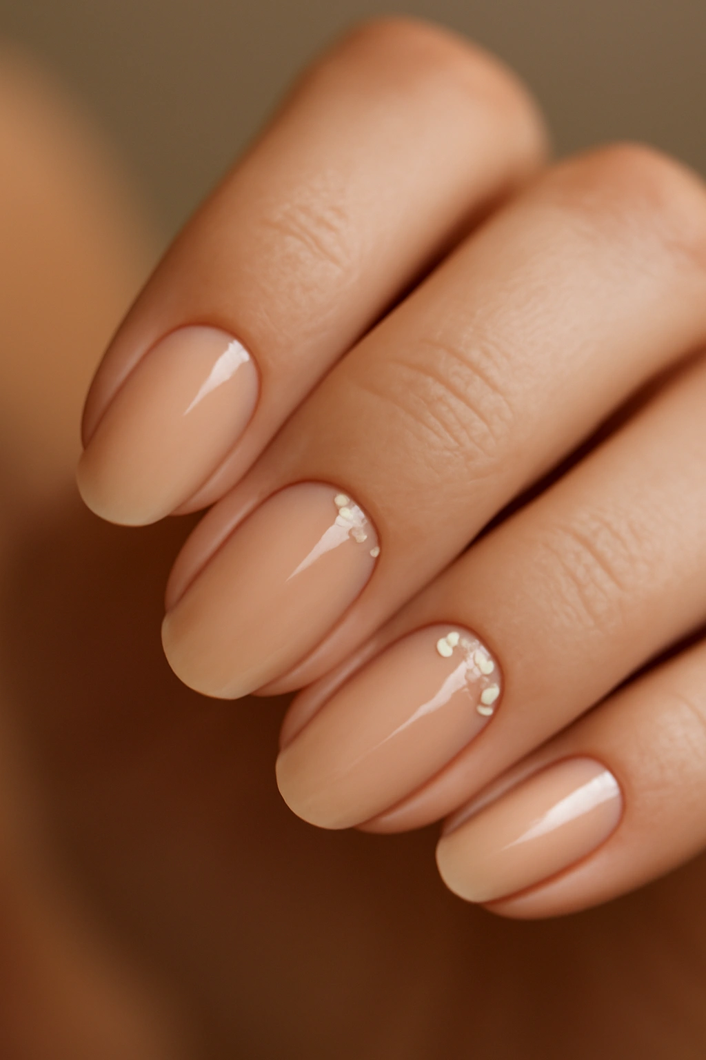 Nude nails with rhinestones along the cuticle