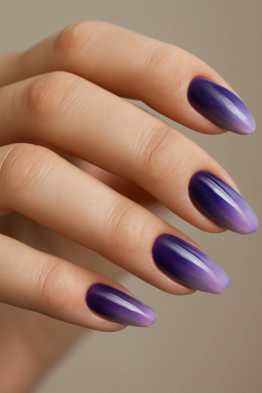 Close-up of ombre purple nails transitioning from dark to light