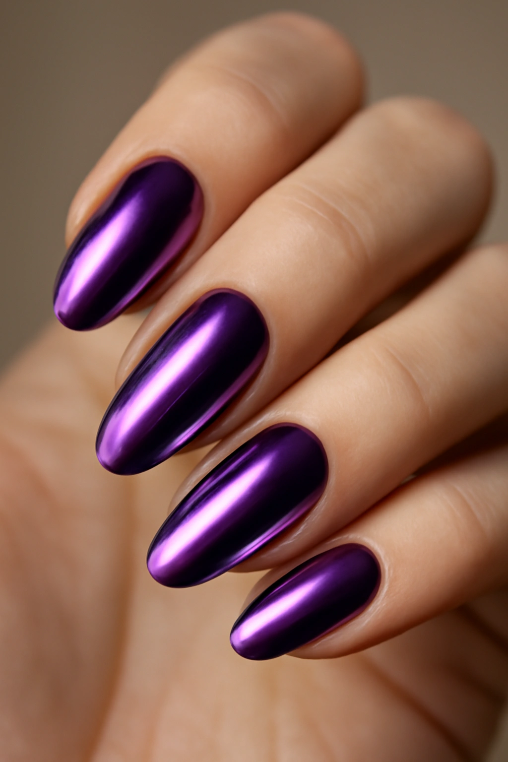 Close-up of purple chrome nails with mirror finish on a hand