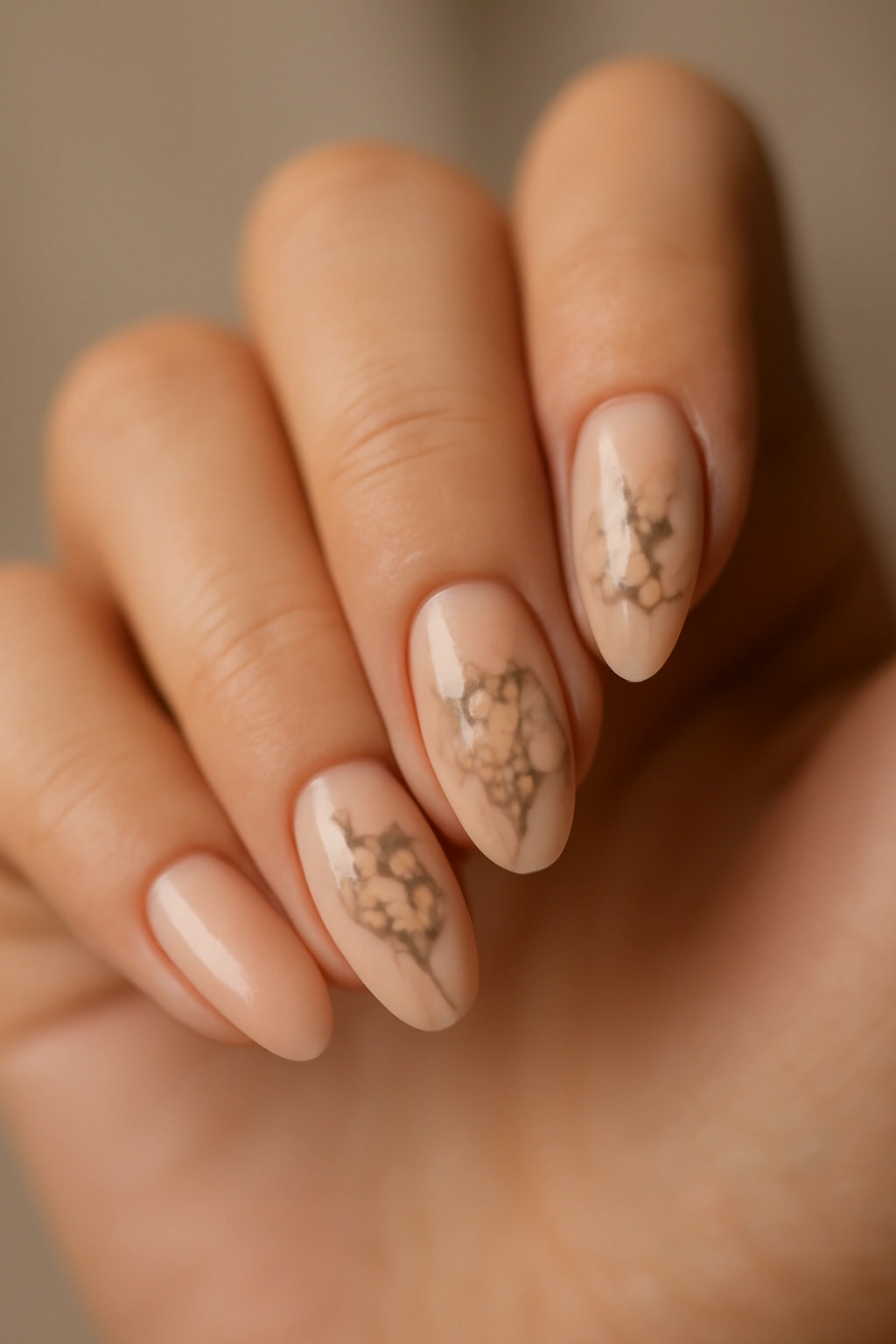 Close-up of nude nails with delicate floral art on a nude base