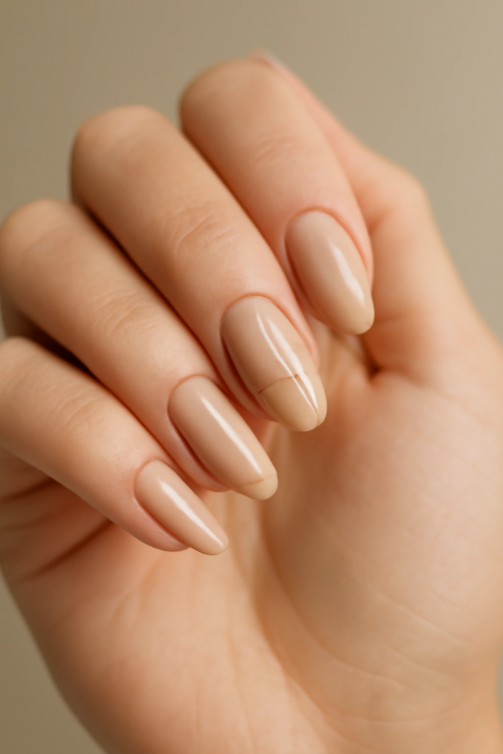 Close-up of hands with nude nails featuring minimalist line art on an accent nail